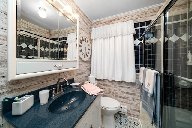 bathroom with toilet, a shower with door, wood walls, and vanity