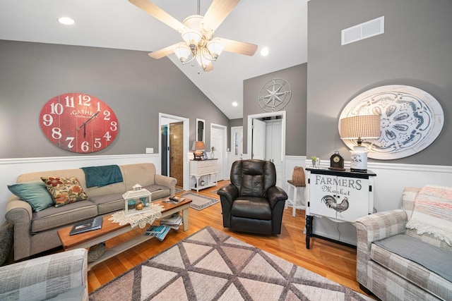 living room featuring hardwood / wood-style flooring, lofted ceiling, and ceiling fan