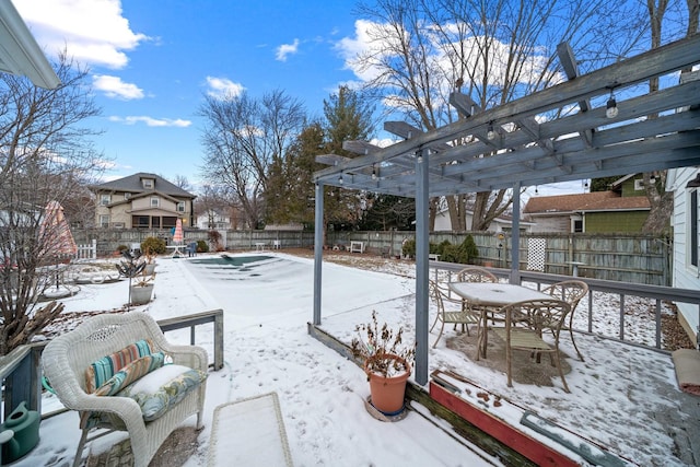 snow covered patio with a pergola