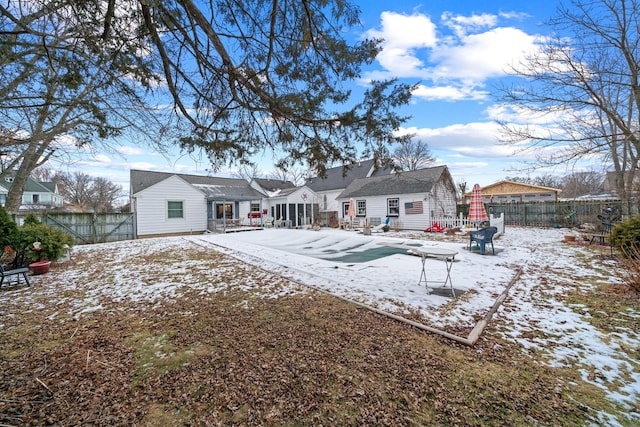 view of snow covered back of property