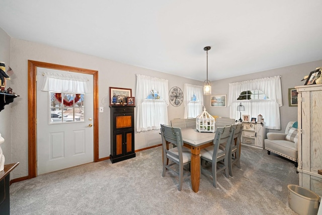 carpeted dining space with a wealth of natural light