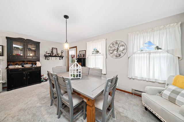 dining room featuring carpet floors, a baseboard radiator, and a healthy amount of sunlight