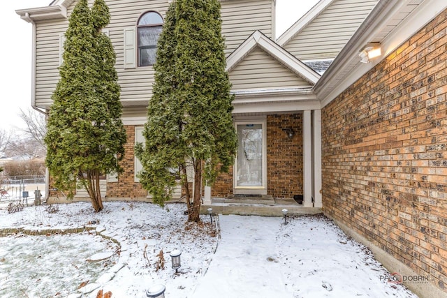 view of snow covered property entrance