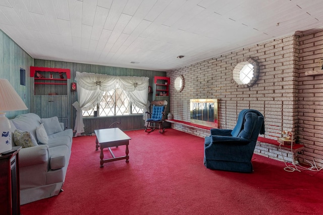 carpeted living room featuring brick wall and a fireplace