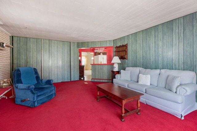 living room featuring wooden walls and carpet flooring