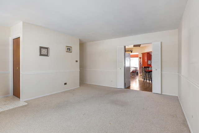 unfurnished room with light colored carpet