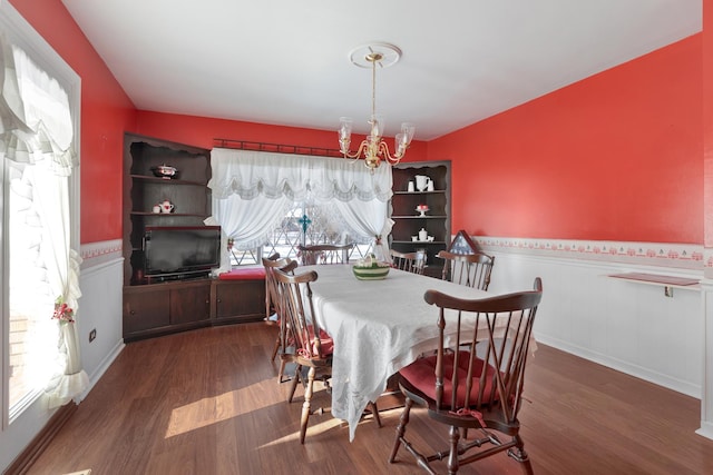 dining room featuring dark wood-type flooring and a notable chandelier