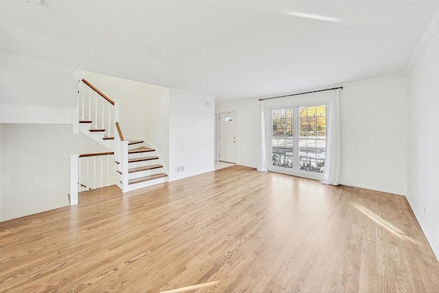 unfurnished living room featuring ornamental molding and light hardwood / wood-style floors