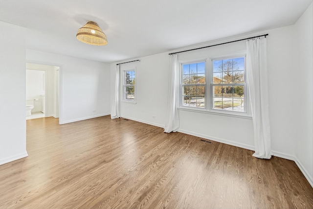 spare room with light hardwood / wood-style flooring