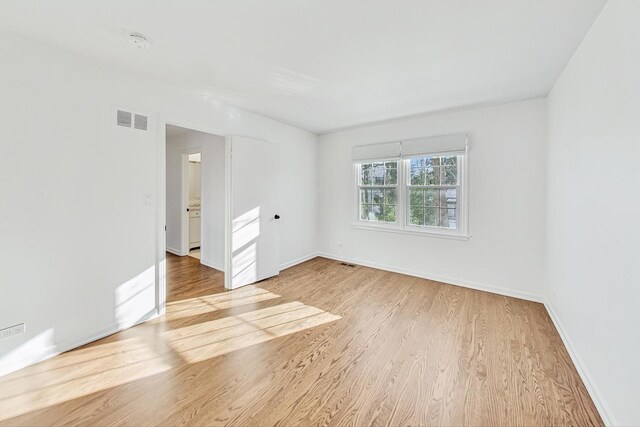 empty room with light hardwood / wood-style floors