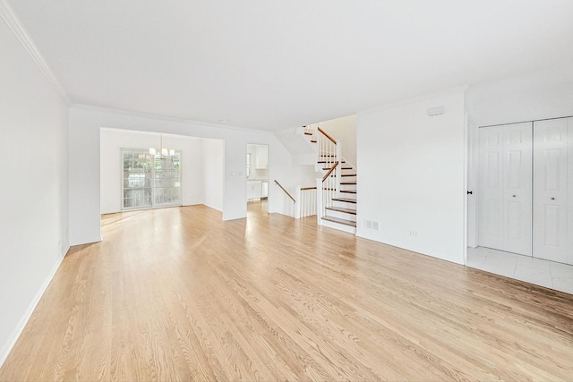 interior space featuring an inviting chandelier, light wood-type flooring, and crown molding