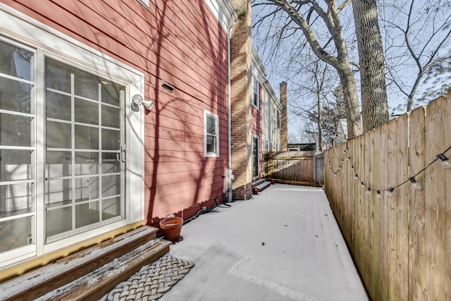 view of snow covered exterior featuring a patio