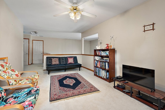 carpeted living room featuring ceiling fan