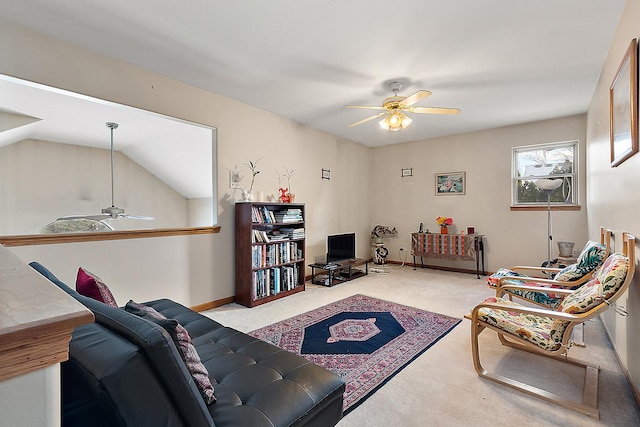 living room with ceiling fan, vaulted ceiling, and light colored carpet