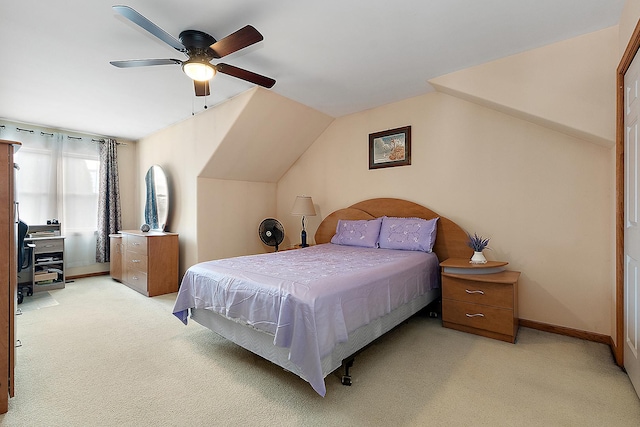 bedroom with vaulted ceiling, light colored carpet, and ceiling fan