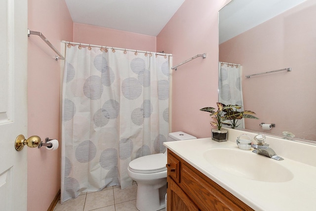 bathroom with tile patterned flooring, vanity, and toilet