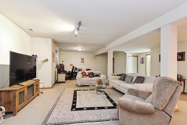 carpeted living room with track lighting