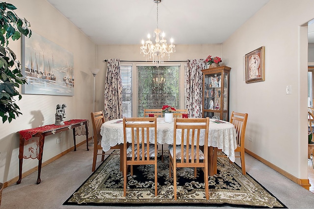 dining room with an inviting chandelier and carpet floors