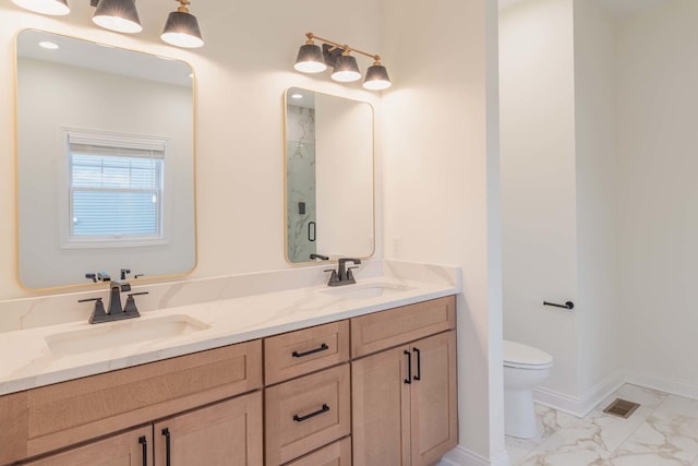 bathroom with toilet, an enclosed shower, and vanity