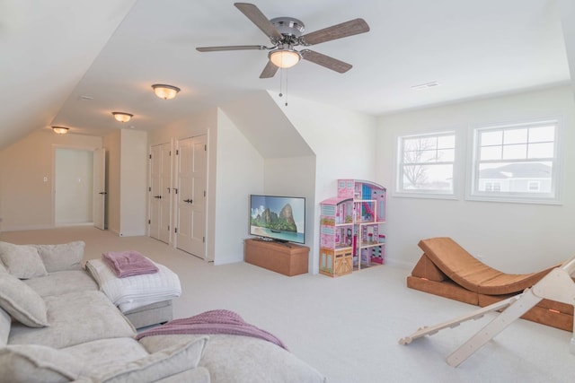 carpeted living room featuring ceiling fan and vaulted ceiling