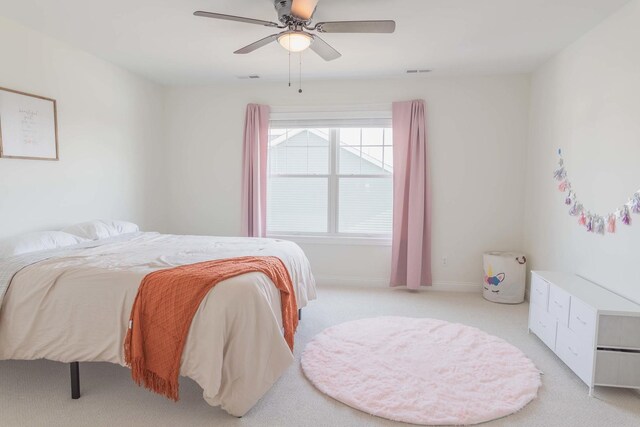 bedroom featuring light colored carpet and ceiling fan