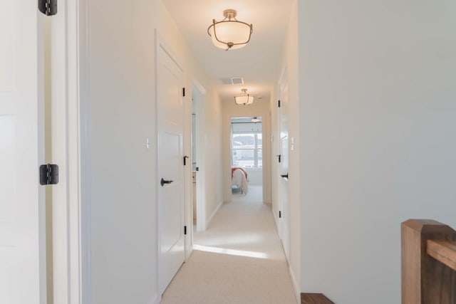 corridor with light colored carpet