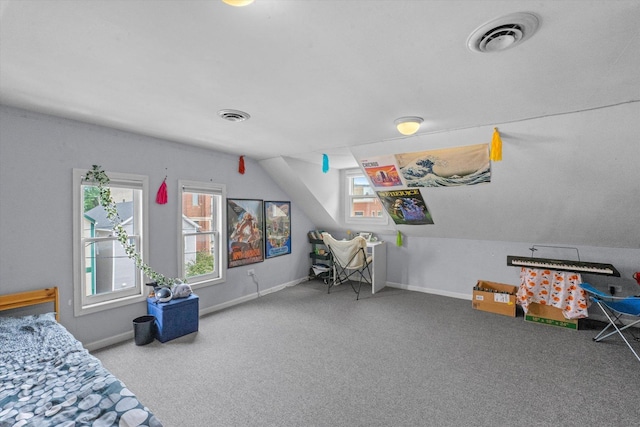 bedroom featuring vaulted ceiling and carpet