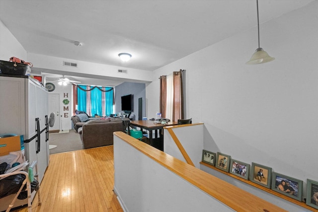 living room featuring ceiling fan and wood-type flooring