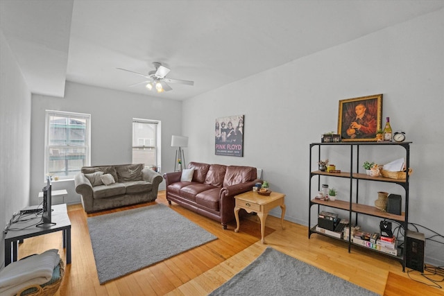 living room featuring ceiling fan and wood-type flooring