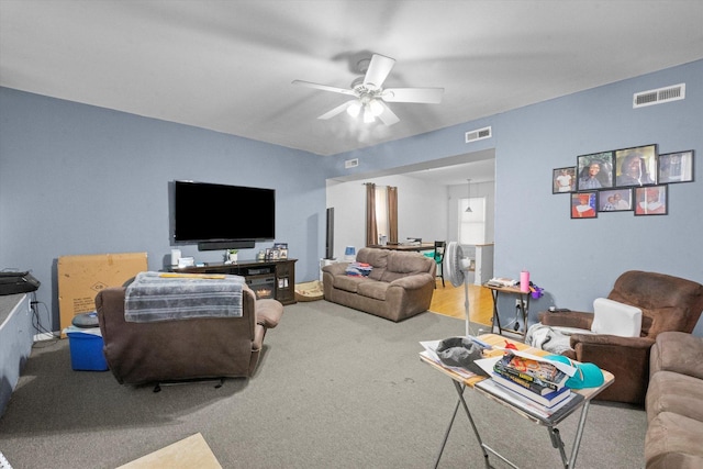 living room with ceiling fan and carpet flooring