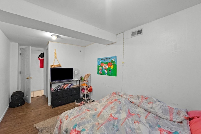 bedroom with dark hardwood / wood-style floors