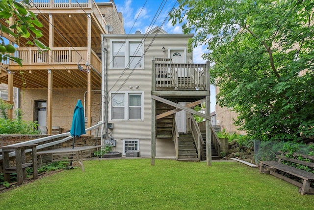 back of house with a deck and a yard