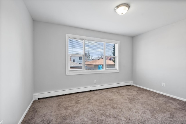 carpeted spare room featuring a baseboard radiator