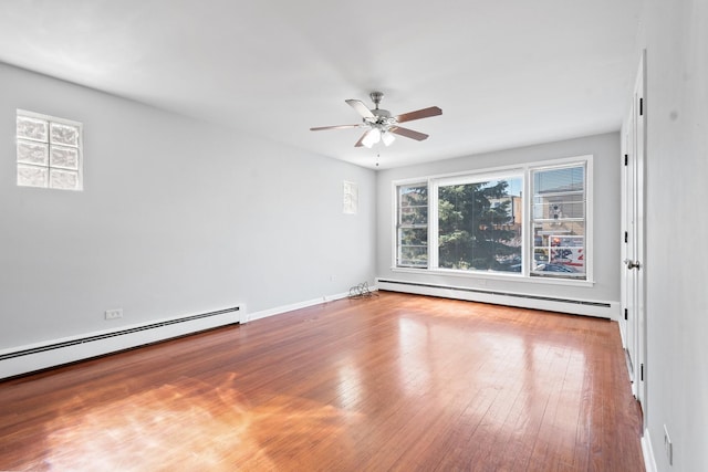 unfurnished room featuring hardwood / wood-style floors, baseboard heating, and ceiling fan