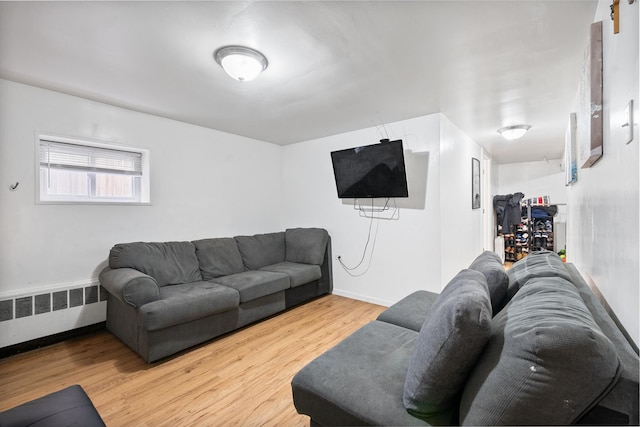 living room featuring radiator and hardwood / wood-style floors