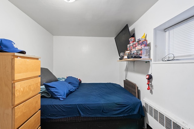 bedroom featuring radiator