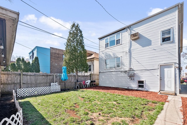 rear view of house featuring a lawn