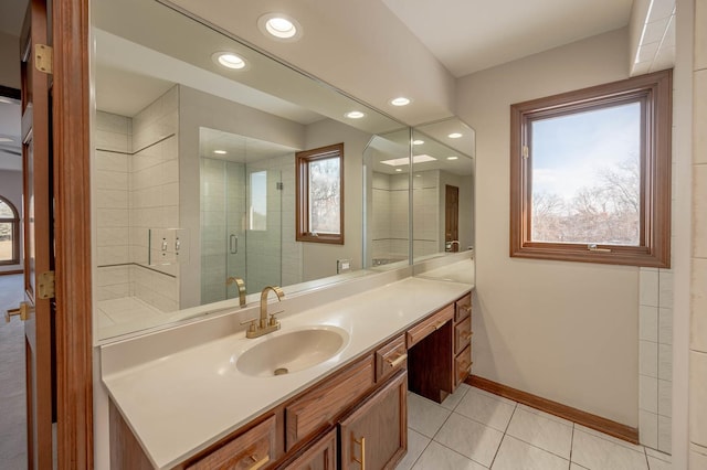 bathroom featuring tile patterned flooring, a shower with shower door, and vanity