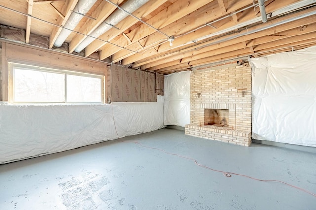 basement with a brick fireplace