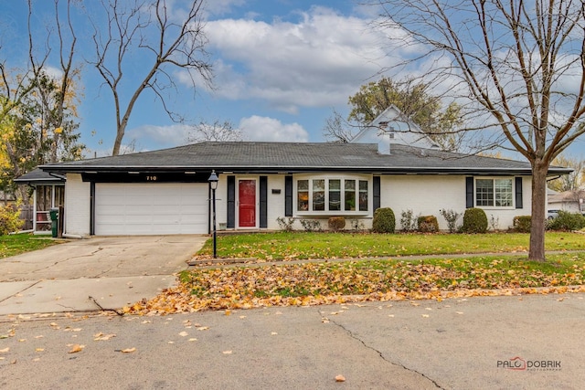 ranch-style home with a front yard and a garage