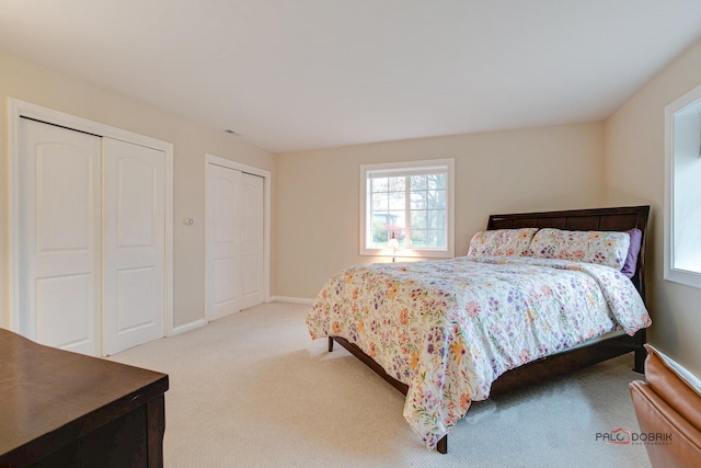 bedroom featuring two closets and carpet floors