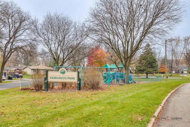 view of property's community featuring a playground and a lawn