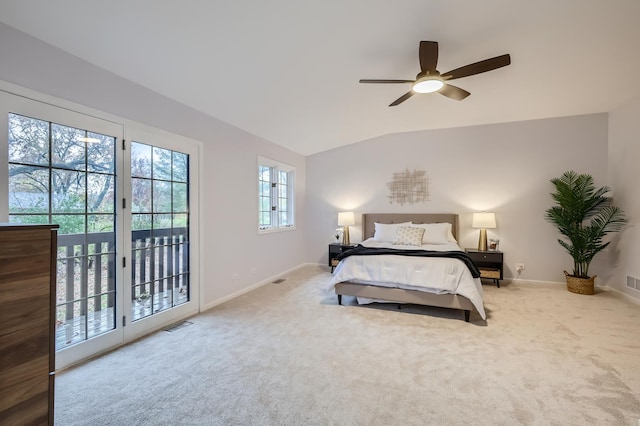 carpeted bedroom with ceiling fan, multiple windows, lofted ceiling, and access to exterior