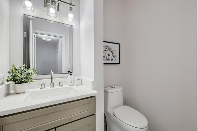 bathroom with toilet and vanity