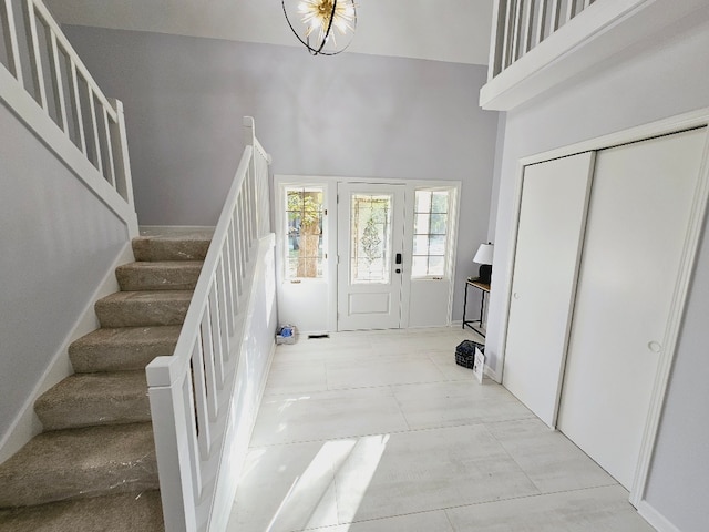 entrance foyer featuring a towering ceiling and a notable chandelier