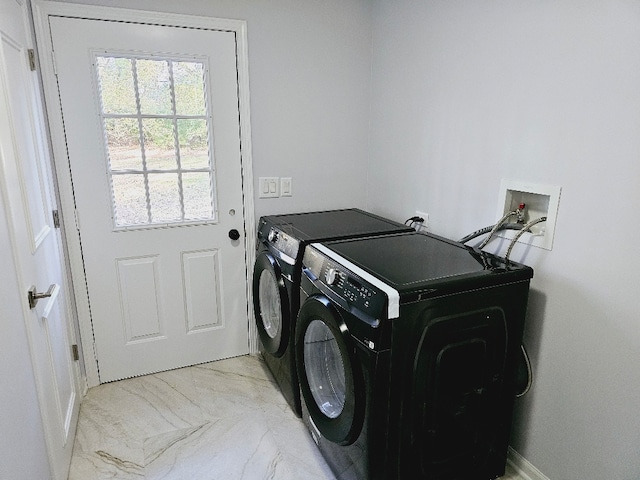 clothes washing area with washing machine and clothes dryer