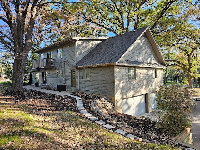 view of property exterior with a balcony and a garage