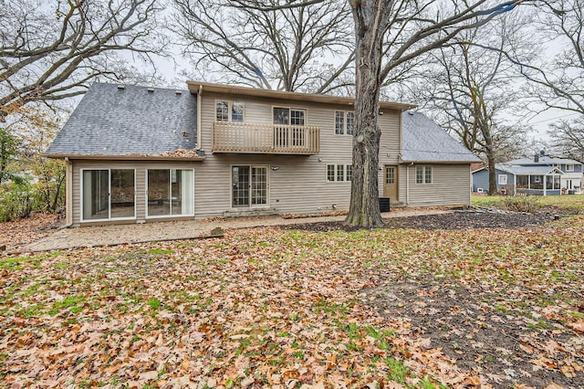 rear view of property with a balcony