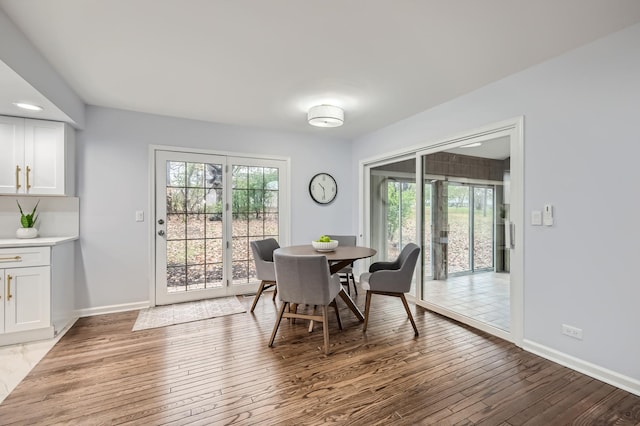 dining space with wood-type flooring