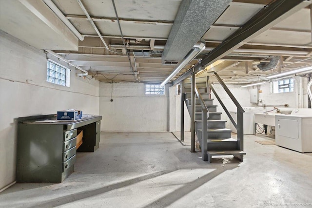 basement featuring a wealth of natural light, washer / clothes dryer, and sink